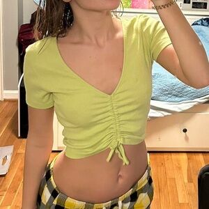 green crop top, ruched in the middle with a tie